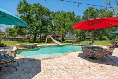 Backyard pool with brickwork and umbrellas